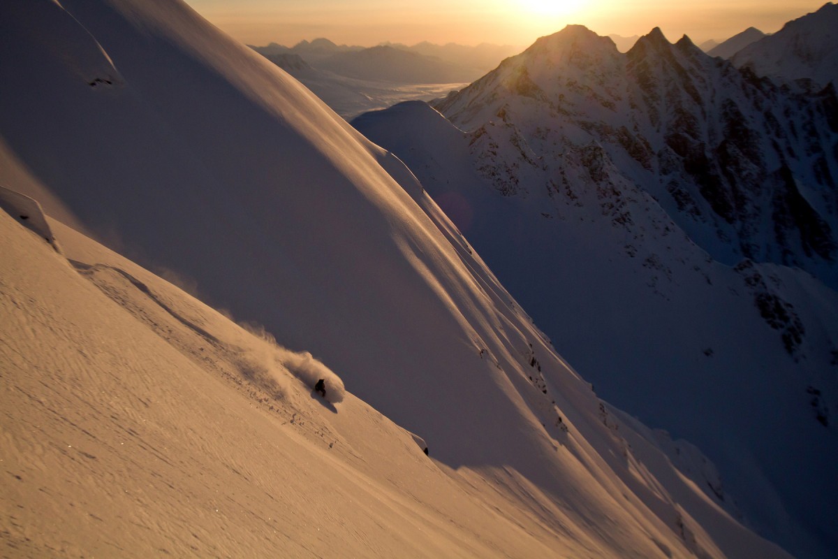 A snowboarder carves the deep powder on a run near Diamond, on Thompson Pass, Valdez.